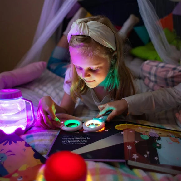 Lumi's First Dance Recital on a bedside table with the Magic Magnifier glowing over an open page