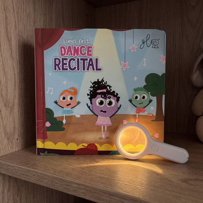 Lumi's First Dance Recital standing on a nursery shelf beside the glowing Magic Magnifier